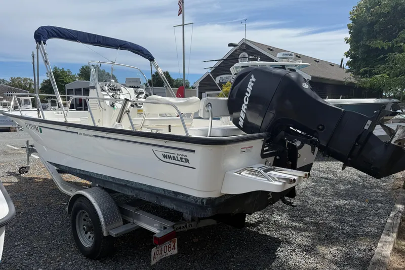 Slide: The Image of 2007 Boston Whaler 190 Montauk boat with Mercury engine on trailer. - 2