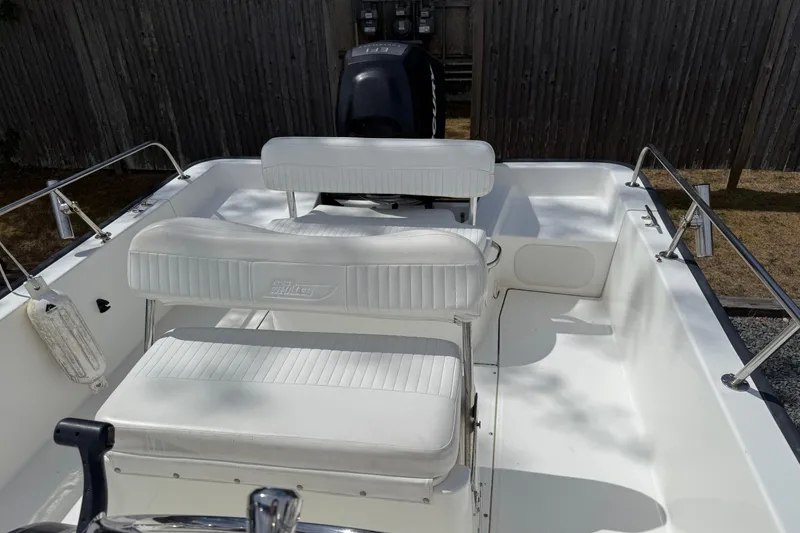 Slide: The Image of 2007 Boston Whaler 190 Montauk boat interior with white seating and railing. - 7