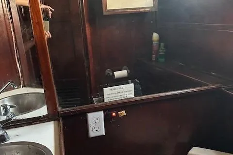Slide: The Image of 1979 Sun Harbor Sundeck Trawler bathroom with wooden interior and sink. - 15