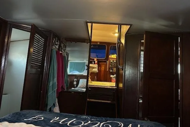 Slide: The Image of Interior of 1979 Sun Harbor Sundeck Trawler with wooden cabinetry and cozy living space. - 16