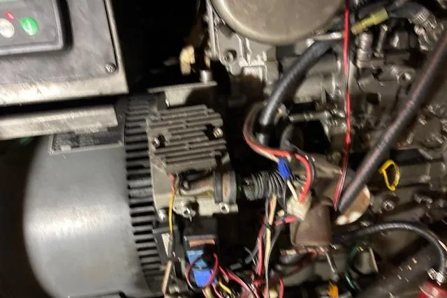 Slide: The Image of Engine components of a 1979 Custom Sun Harbor Sundeck Trawler with visible wiring and machinery. - 25