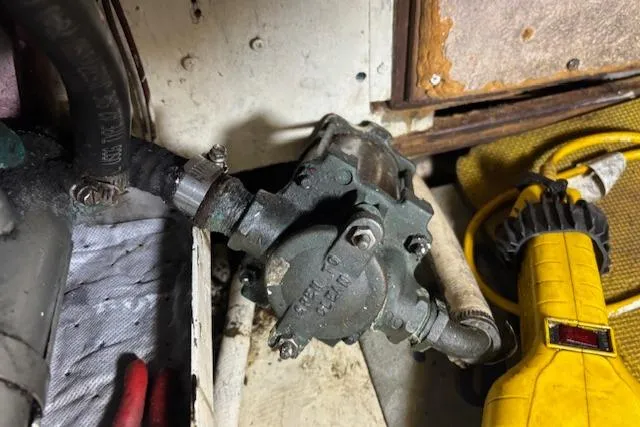 Slide: The Image of Engine compartment of 1979 Custom Sun Harbor Sundeck Trawler with mechanical components. - 26