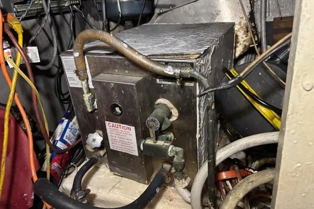 Slide: The Image of 1979 Custom Sun Harbor Sundeck Trawler engine room with wiring and equipment. - 27