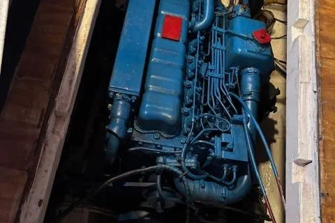 Slide: The Image of Engine of 1979 Custom Sun Harbor Sundeck Trawler, painted blue, in engine compartment. - 28