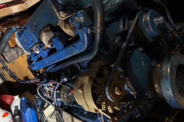 Slide: The Image of Engine of 1979 Custom Sun Harbor Sundeck Trawler, showcasing mechanical components and wiring. - 29