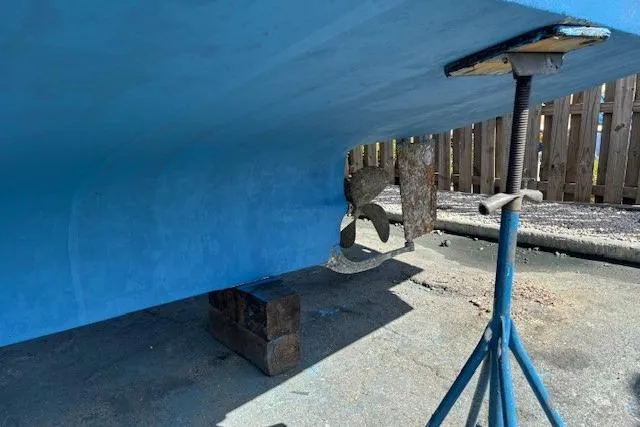 Slide: The Image of Bottom view of a 1979 Custom Sun Harbor Sundeck Trawler on stands, showing propeller and hull. - 37