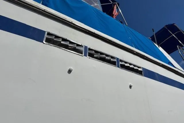 Slide: The Image of 1979 Custom Sun Harbor Sundeck Trawler with blue canopy and side vents. - 38