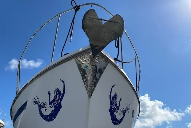 Slide: The Image of 1979 Custom Sun Harbor Sundeck Trawler with mermaid decals and heart-shaped anchor. - 39