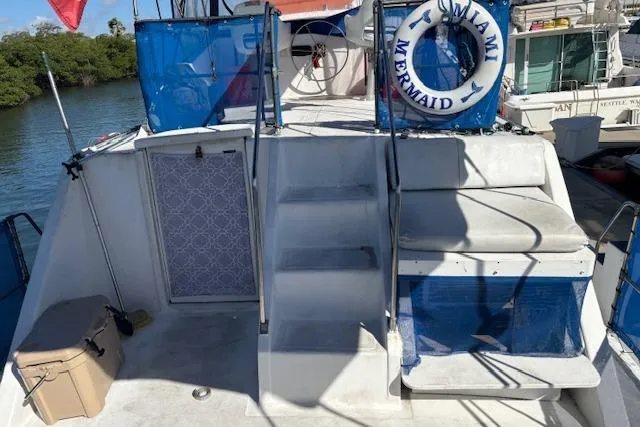 Slide: The Image of 1979 Custom Sun Harbor Sundeck Trawler with stairs, life ring, and seating area on deck. - 6