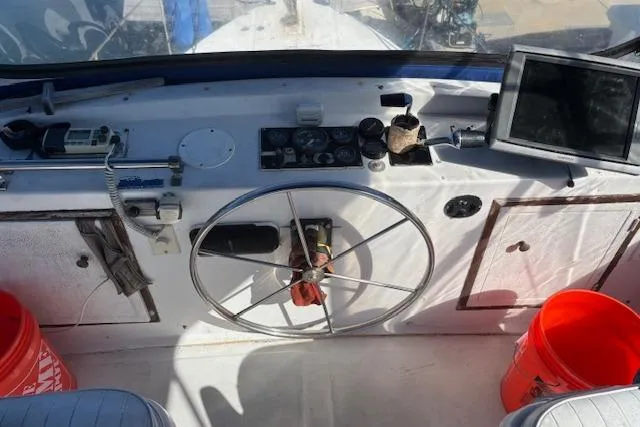 Slide: The Image of Helm of 1979 Custom Sun Harbor Sundeck Trawler with steering wheel and navigation equipment. - 7