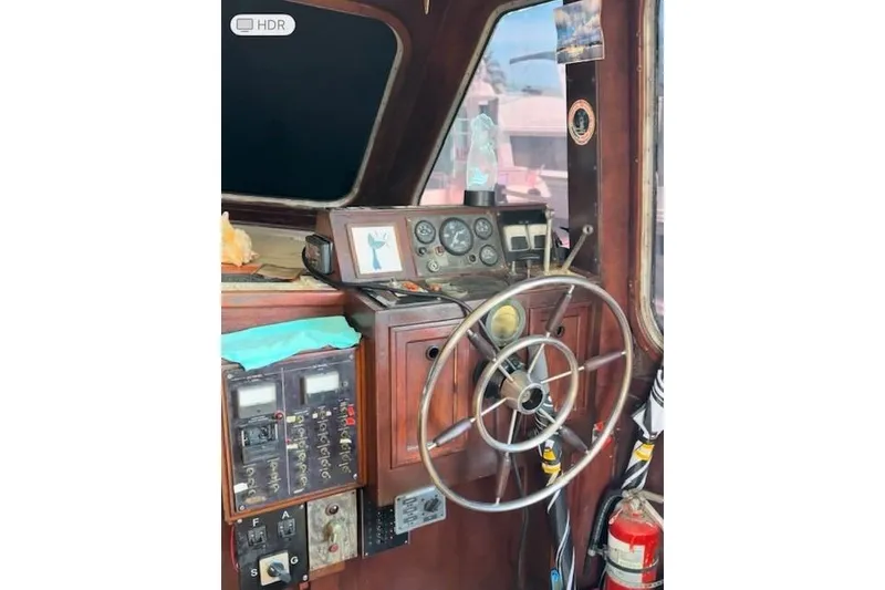 Slide: The Image of 1979 Custom Sun Harbor Sundeck Trawler helm with vintage controls and steering wheel. - 9