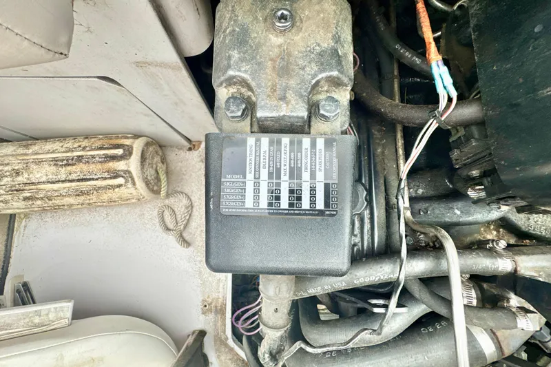 Slide: The Image of Engine compartment of a 1999 Four Winns 220 Horizon boat, showing wiring and components. - 1