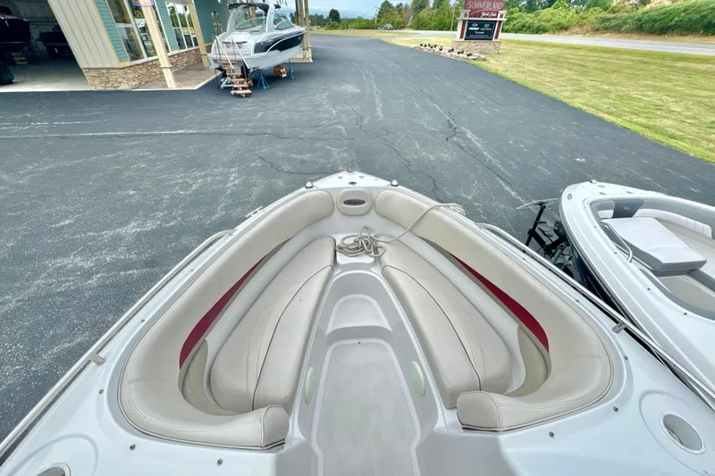 Slide: The Image of 1999 Four Winns 220 Horizon boat interior with white seating and red accents. - 3