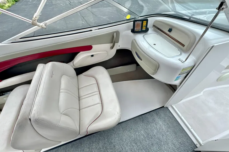 Slide: The Image of Interior of 1999 Four Winns 220 Horizon boat with white seating and dashboard. - 5