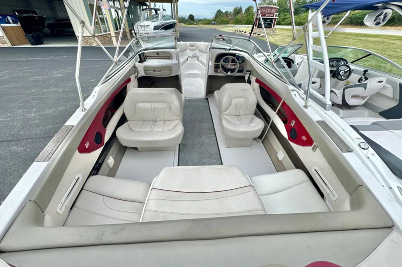 Slide: The Image of 1999 Four Winns 220 Horizon boat interior with white seating and red accents. - 9