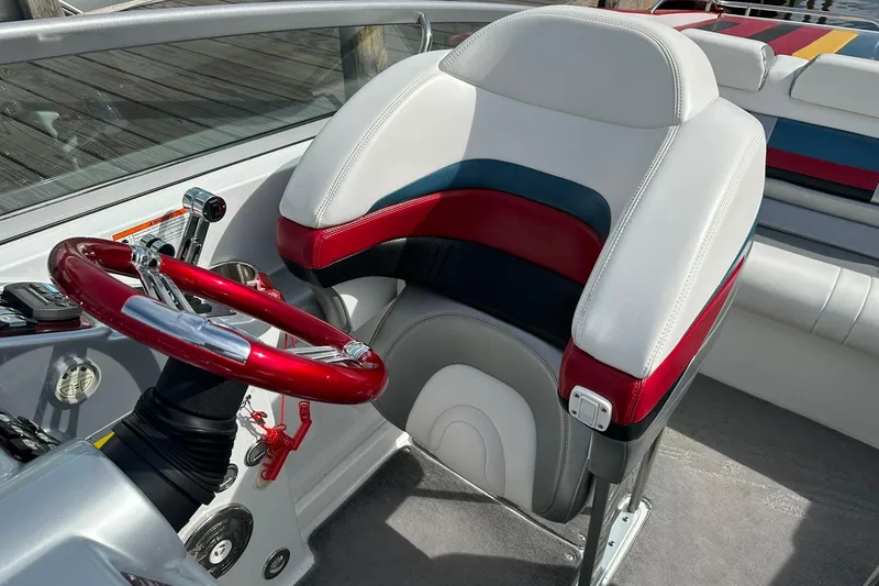 Slide: The Image of 2008 Formula 292 FASTech boat cockpit with red steering wheel and white seat. - 12