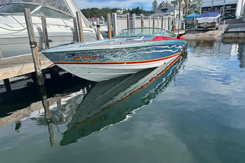 Slide: The Image of 2008 Formula 292 FASTech boat docked, vibrant design reflecting on calm water. - 2