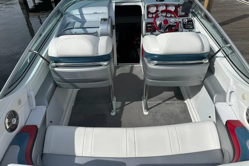 Slide: The Image of 2008 Formula 292 FASTech boat interior with white and blue seating, red steering wheel, and dashboard. - 6