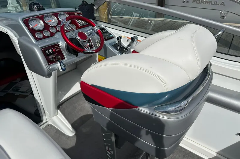 Slide: The Image of Interior of a 2008 Formula 292 FASTech boat with white seating and red steering wheel. - 8