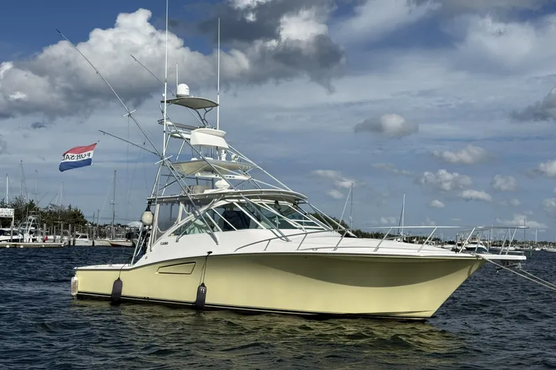 The Image of 2005 Cabo 40 Express yacht cruising on open sea with fishing rods. - 0