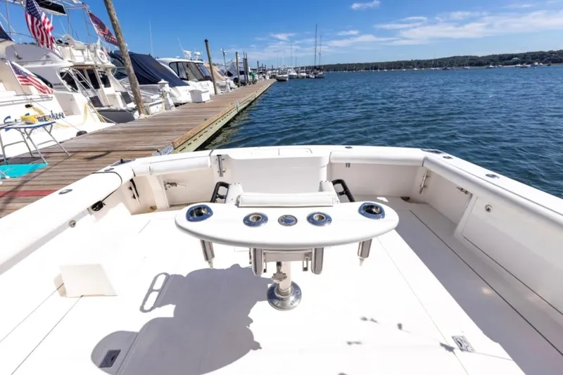 Slide: The Image of 2005 Cabo 40 Express yacht with spacious deck and fishing chair on a sunny day. - 11