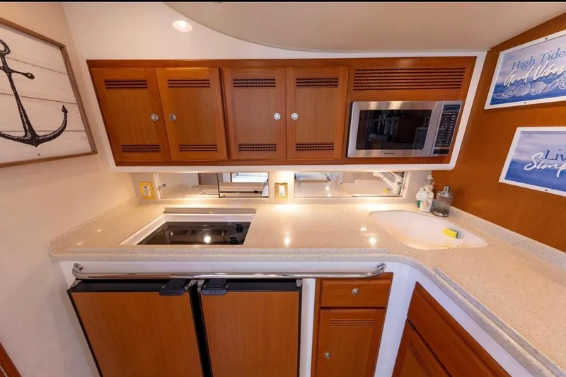 Slide: The Image of Interior of 2005 Cabo 40 Express yacht with cozy seating and nautical decor. - 17