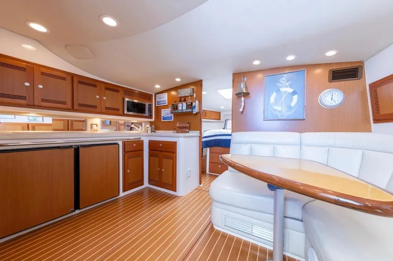 Slide: The Image of Interior of 2005 Cabo 40 Express yacht with cozy seating and nautical decor. - 18