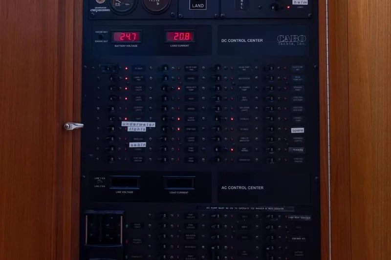 Slide: The Image of 2005 Cabo 40 Express yacht interior with wood cabinetry, white seating, and nautical decor. - 19