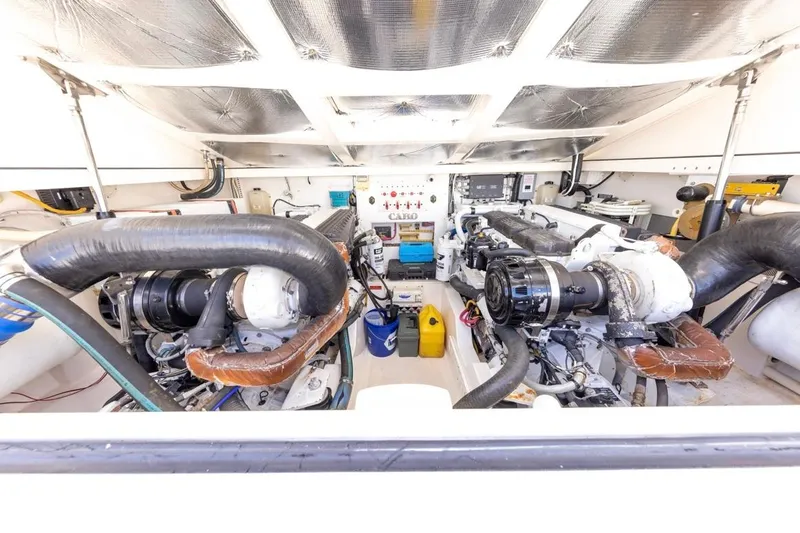 Slide: The Image of Luxurious 2005 Cabo 40 Express yacht interior with modern kitchen and wooden cabinetry. - 23