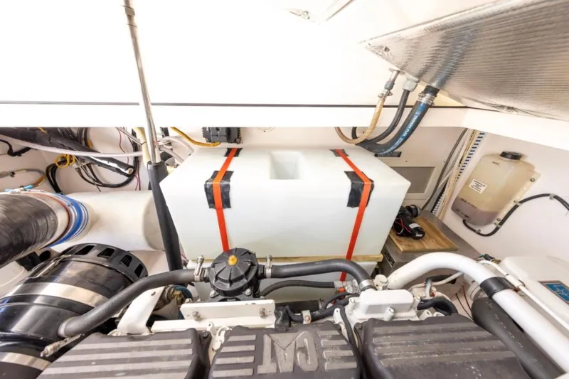 Slide: The Image of Engine room of 2005 Cabo 40 Express boat with visible components and wiring. - 34