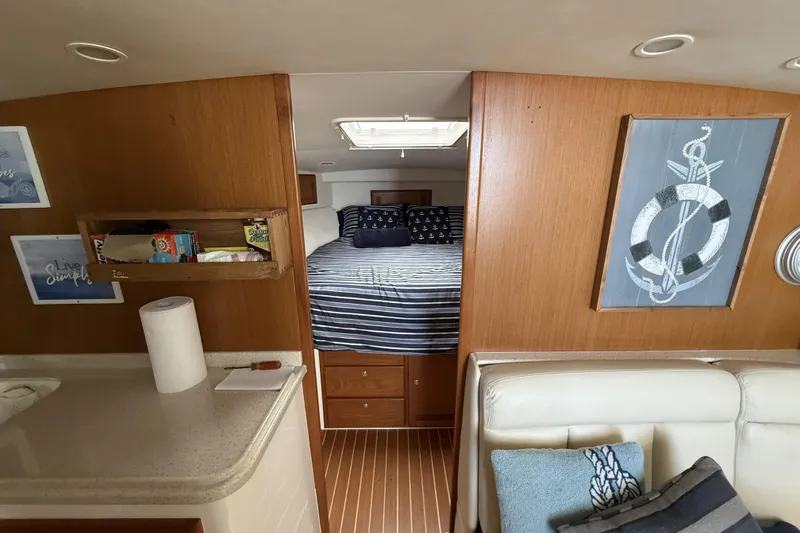 Slide: The Image of 2005 Cabo 40 Express yacht with tower against a blue sky. - 36