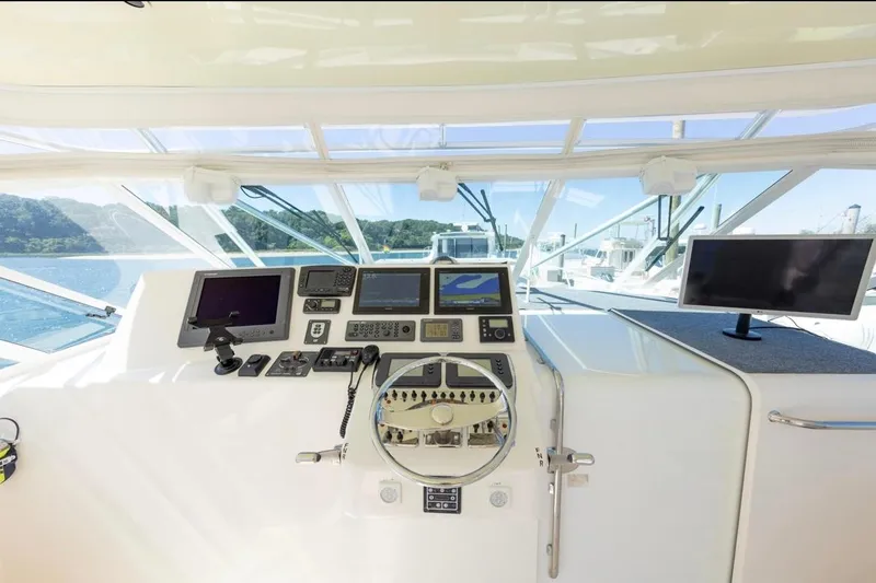 Slide: The Image of Helm of 2005 Cabo 40 Express with Garmin navigation equipment and steering wheel. - 6