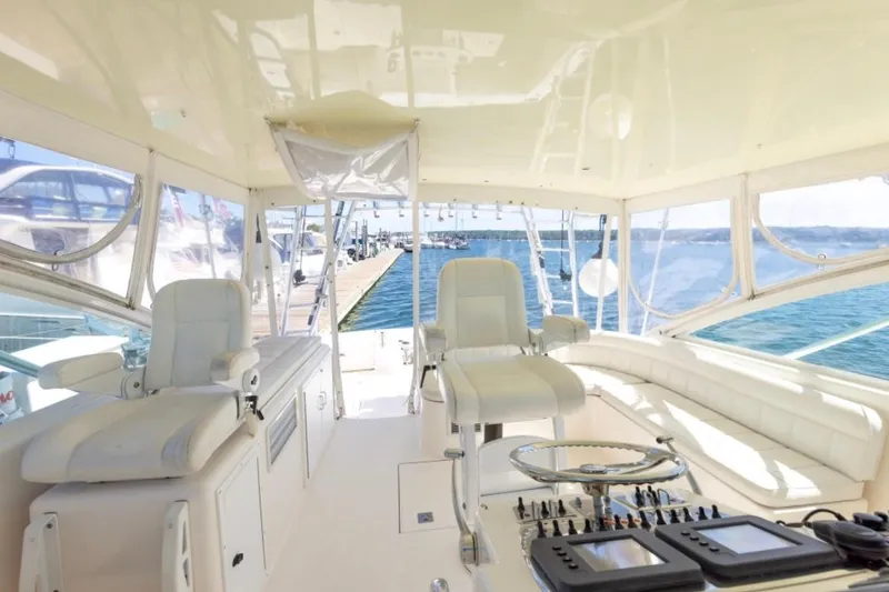 Slide: The Image of Interior of 2005 Cabo 40 Express yacht with white seating and American flag. - 8