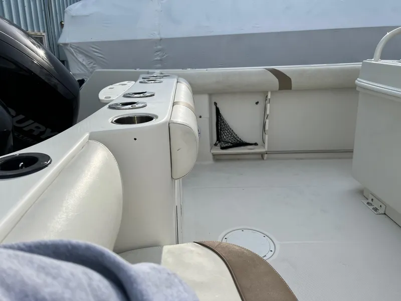 Slide: The Image of Interior view of a 2013 Sailfish 270 CC boat, featuring seating and storage compartments. - 11