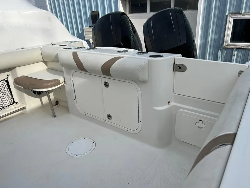 Slide: The Image of 2013 Sailfish 270 CC boat interior with seating and storage compartments. - 13