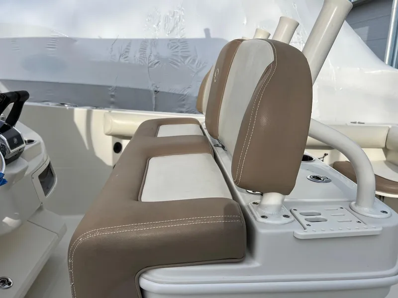 Slide: The Image of 2013 Sailfish 270 CC boat interior with beige and white seating. - 14