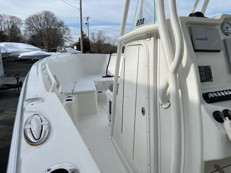 Slide: The Image of 2013 Sailfish 270 CC boat interior with control panel and seating area. - 16