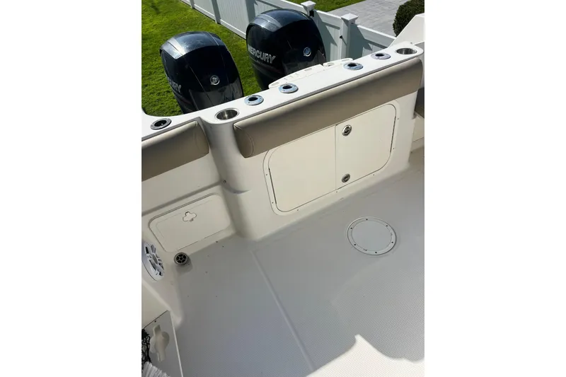 Slide: The Image of 2013 Sailfish 270 CC boat deck with dual Mercury engines, white finish. - 23