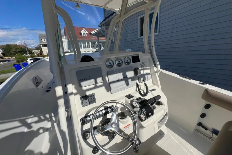 Slide: The Image of 2013 Sailfish 270 CC boat cockpit with Garmin navigation system and steering wheel. - 26