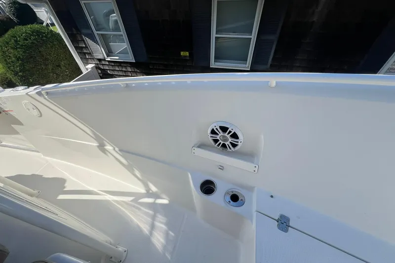 Slide: The Image of 2013 Sailfish 270 CC boat interior with speaker and utility ports. - 29