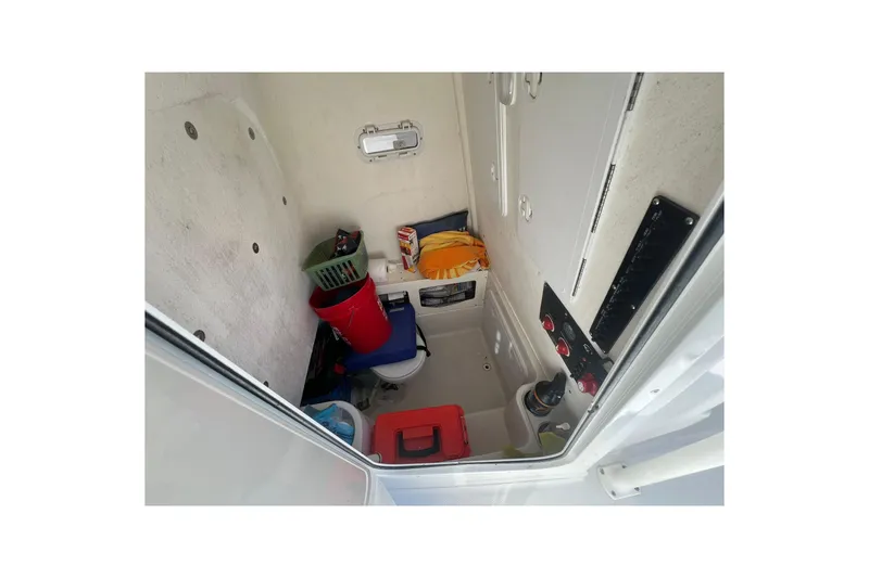 Slide: The Image of Interior of 2013 Sailfish 270 CC boat with storage items and control panel. - 30