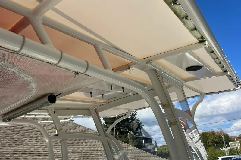 Slide: The Image of 2013 Sailfish 270 CC boat canopy and framework under clear blue sky. - 36