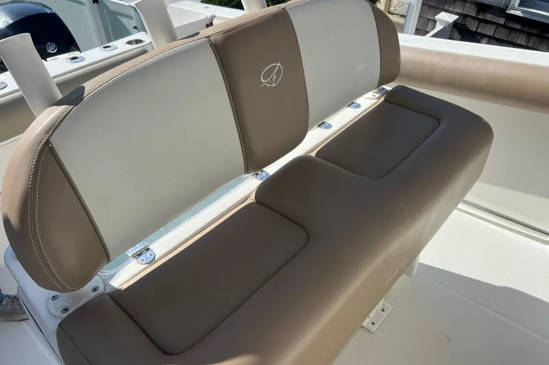 Slide: The Image of 2013 Sailfish 270 CC boat seat with beige and white upholstery. - 39