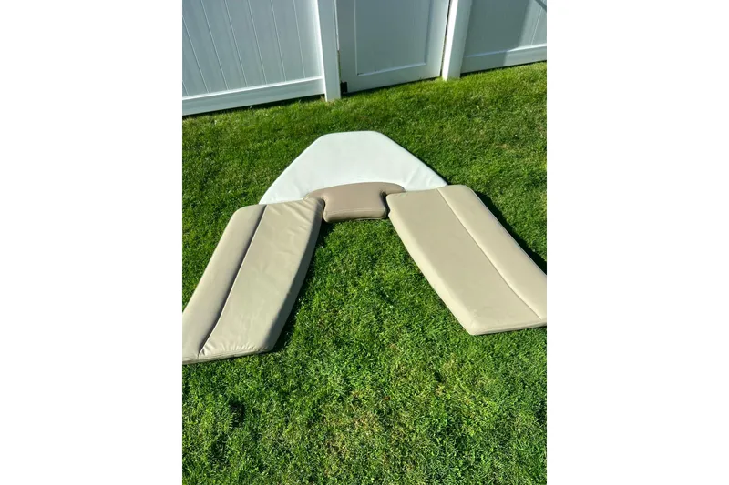 Slide: The Image of Cushions for 2013 Sailfish 270 CC boat on grass, near white fence. - 43