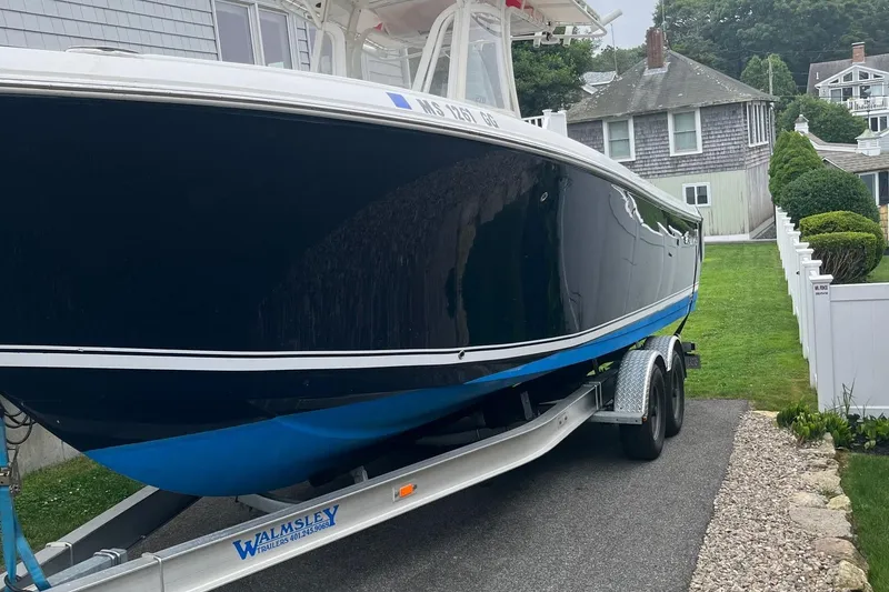 Slide: The Image of 2013 Sailfish 270 CC boat on trailer in residential driveway. - 5