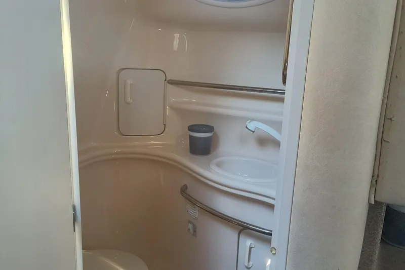 Slide: The Image of Bathroom interior of 2000 Sea Ray 340 Sundancer yacht, featuring sink and storage. - 14