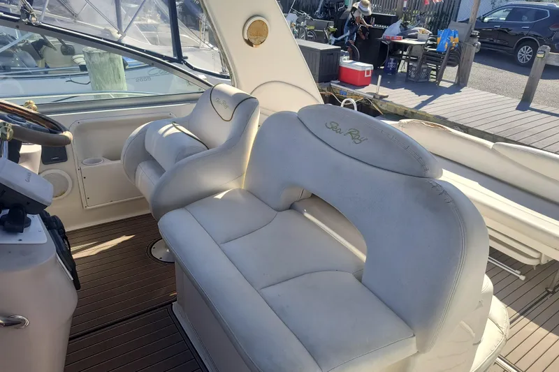 Slide: The Image of 2000 Sea Ray 340 Sundancer boat interior with white seating and steering wheel. - 5
