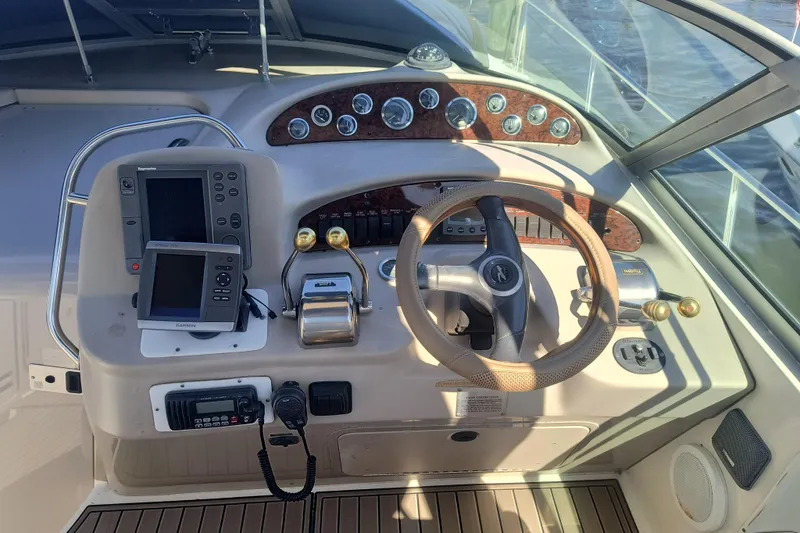 Slide: The Image of Cockpit of 2000 Sea Ray 340 Sundancer with steering wheel and navigation equipment. - 6