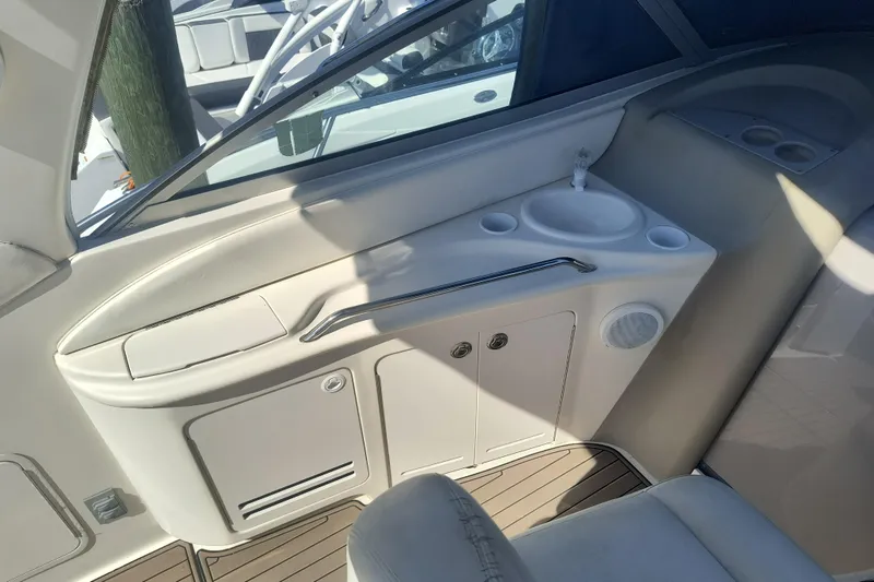 Slide: The Image of Interior view of a 2000 Sea Ray 340 Sundancer boat, featuring a compact sink and storage area. - 7