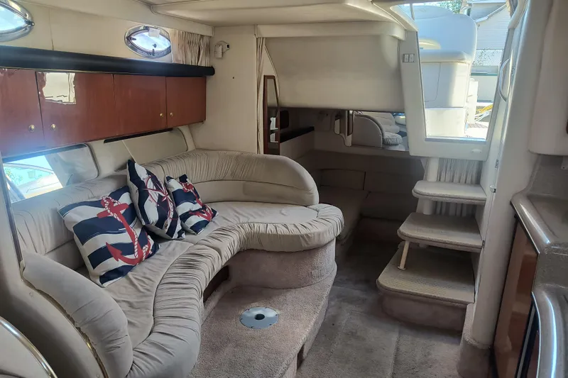 Slide: The Image of Interior of 2000 Sea Ray 340 Sundancer with plush seating and nautical-themed pillows. - 9